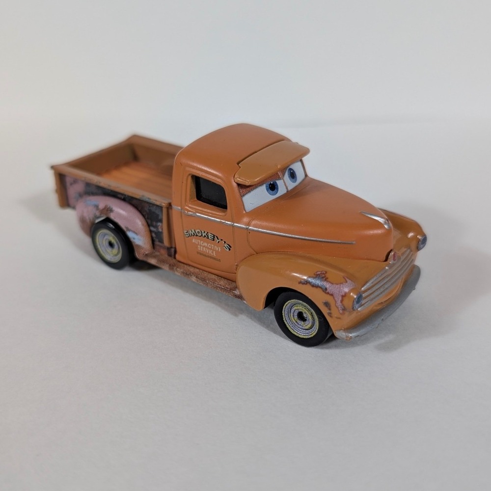 Disney Pixar Cars Smokey Diecast Truck Mattel DXV37 Orange Piston Cup Racing